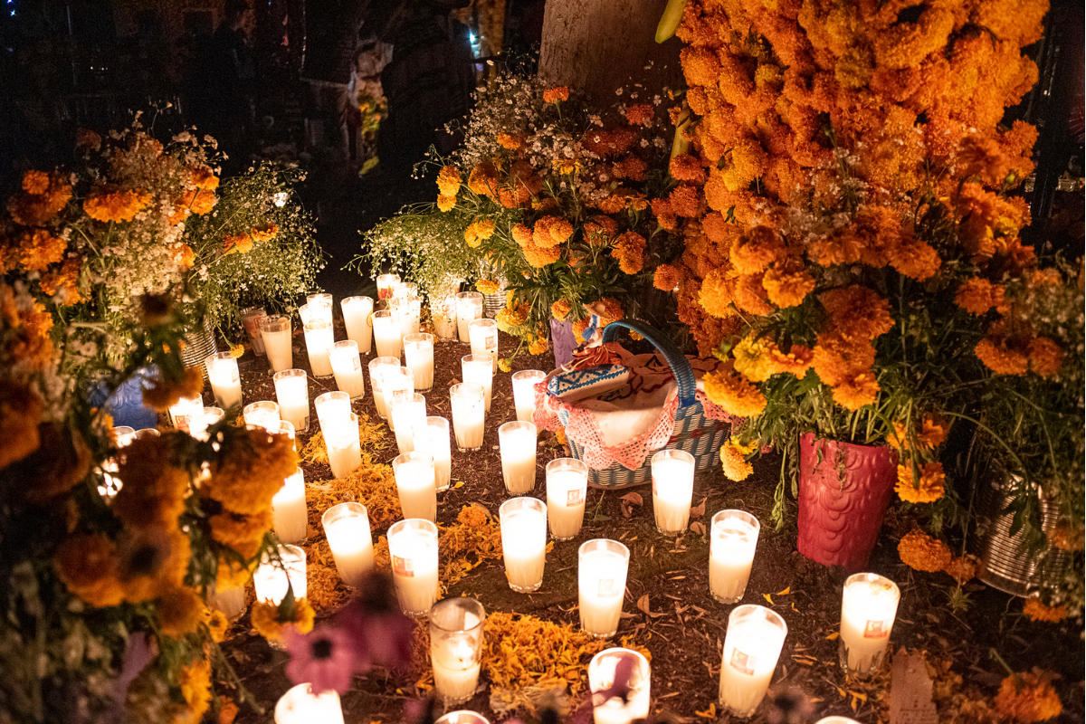 A photograph of candles and flowers, to celebrate Day of the Dead in Mexico. 