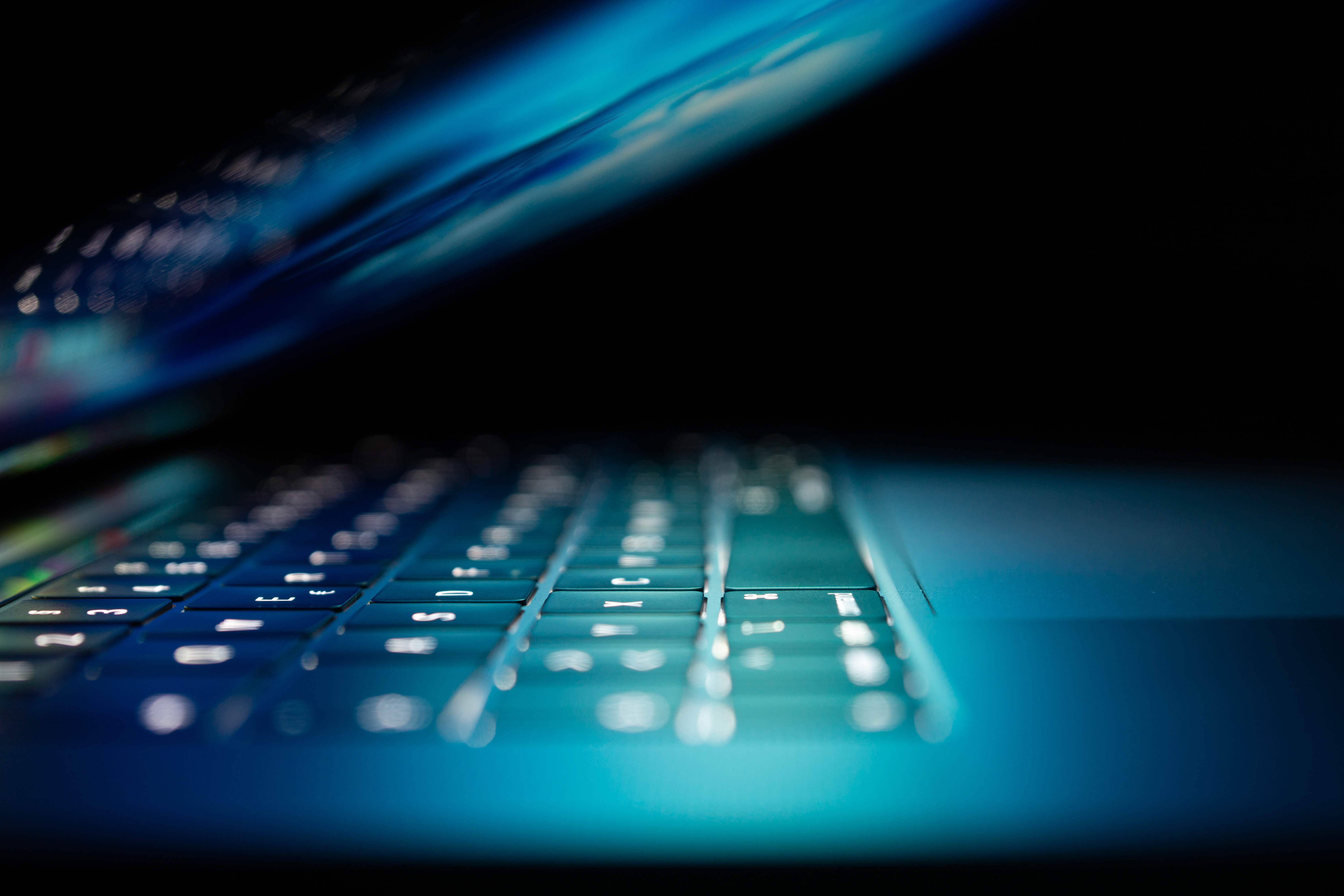 A side-on, close-up picture of a laptop. The picture is slightly blurred.