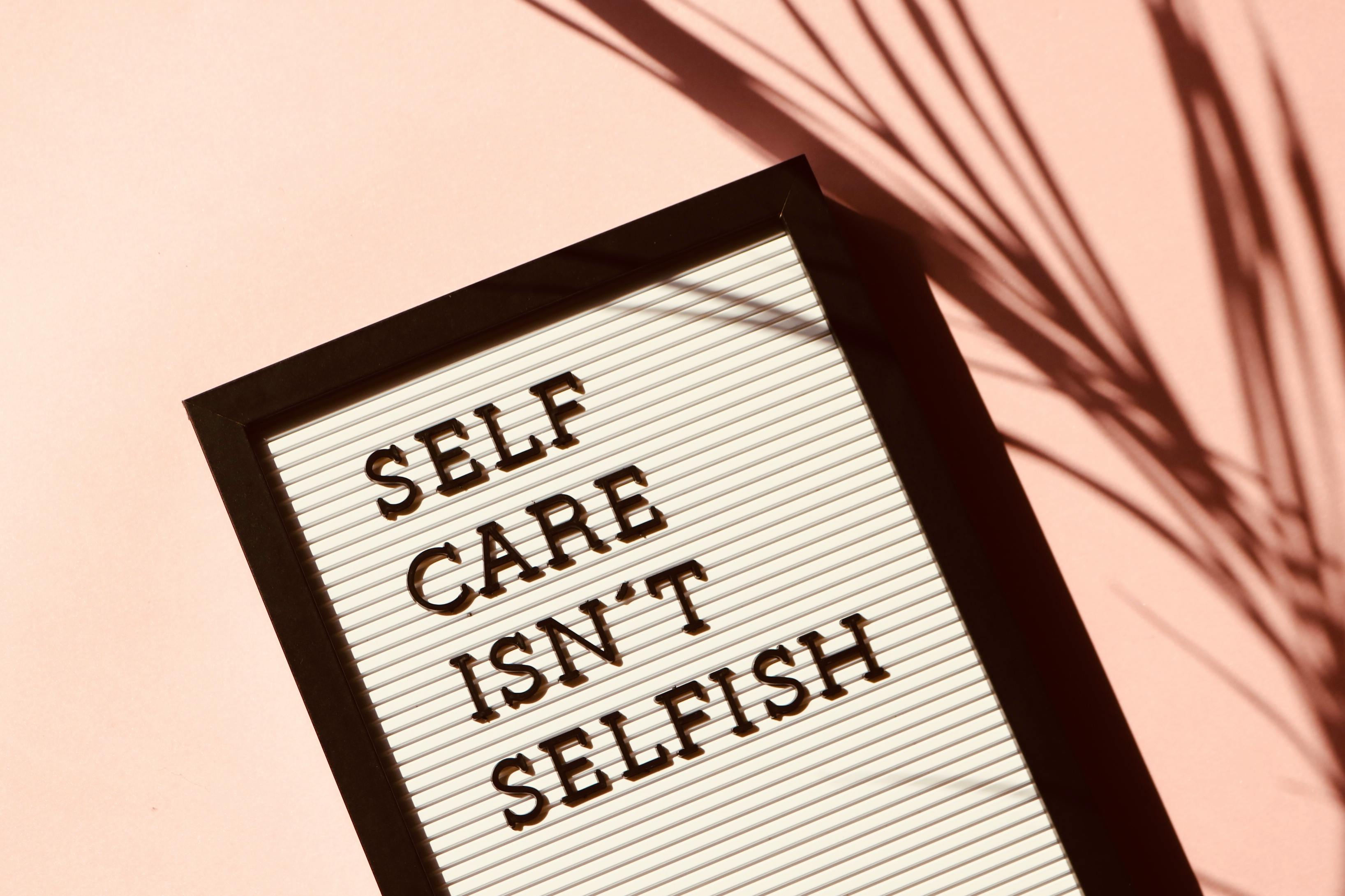 An image of a tablet with 'Self care isn't selfish' written on it.