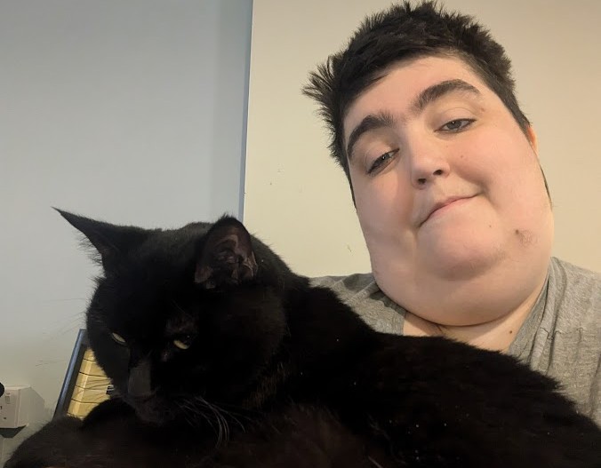 A picture of Morgan with her black cat.