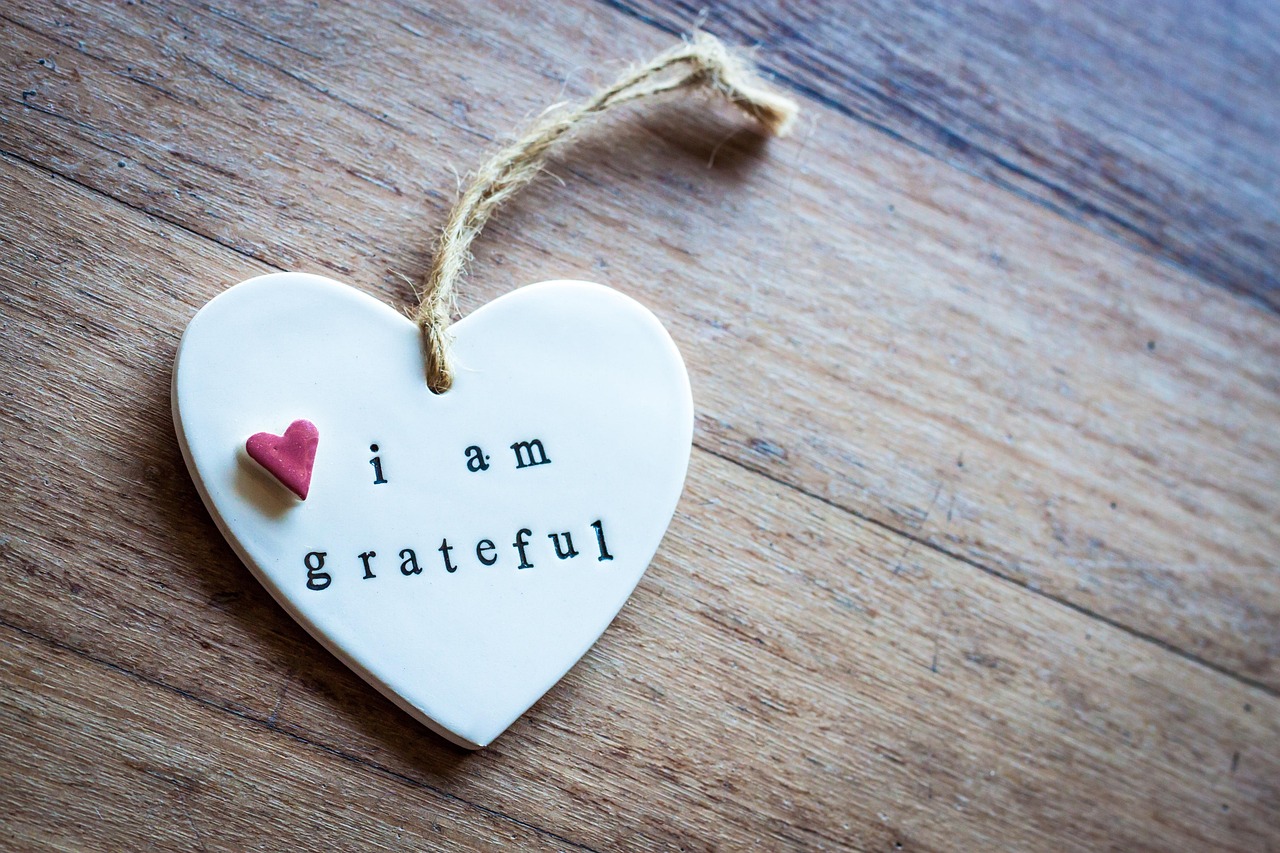 A heart-shaped decoration with 'i am grateful' written on it.
