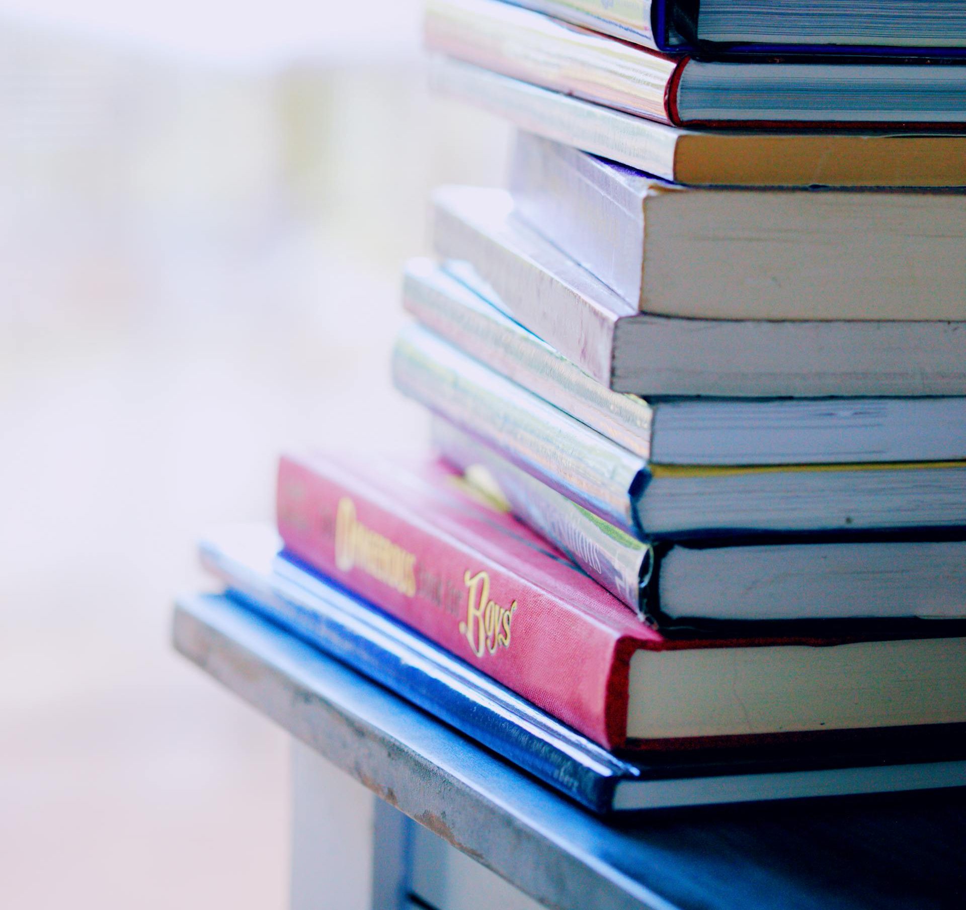 A pile of colourful books on top of each other.
