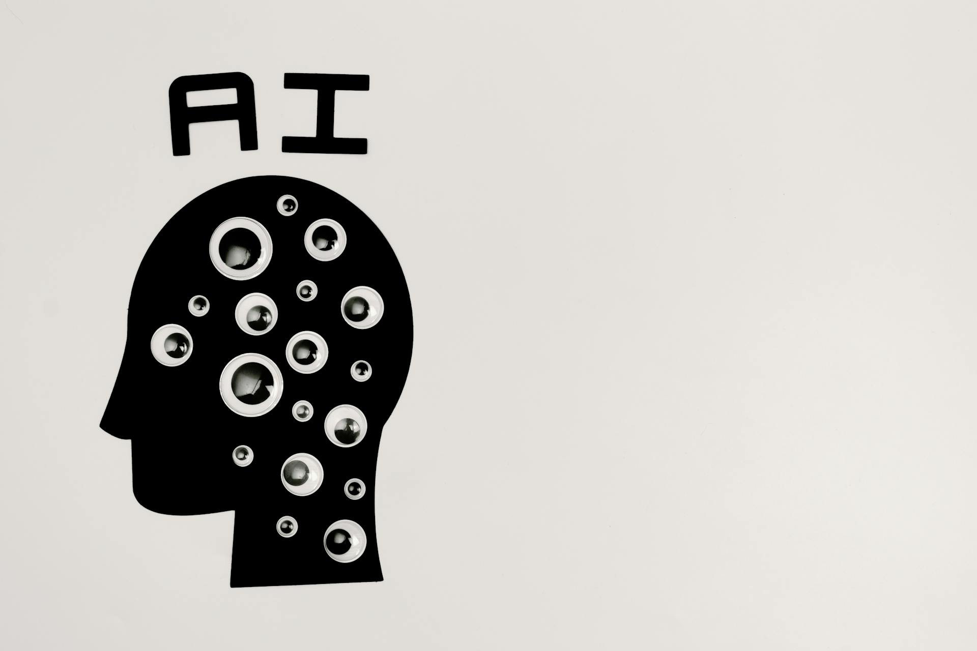 'AI' written above a silhouetted head with circles in it.