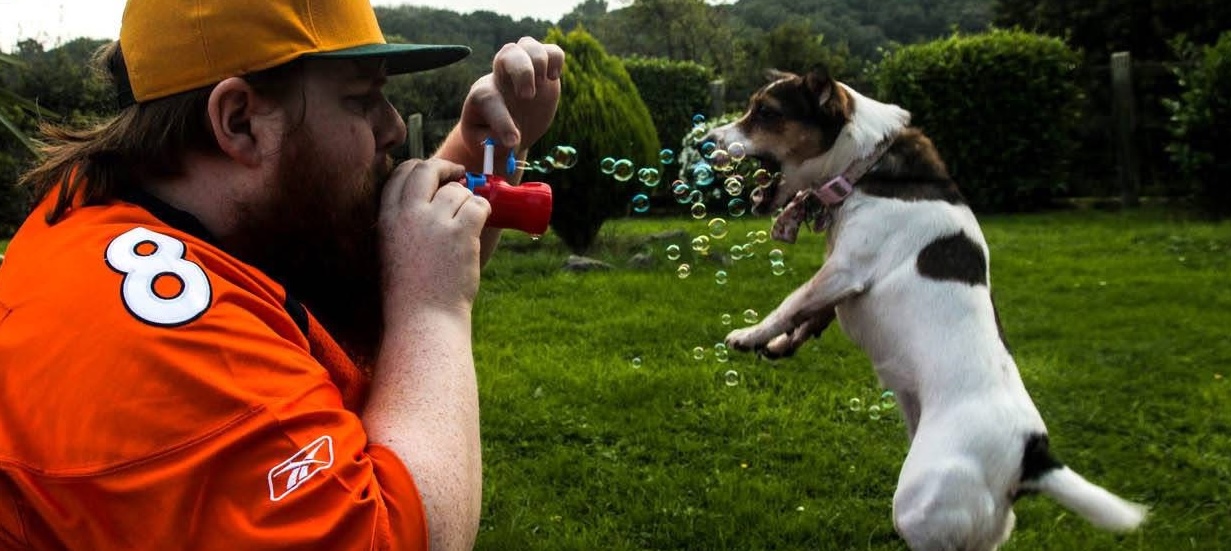 Jimmie and his dog playing in the garden.